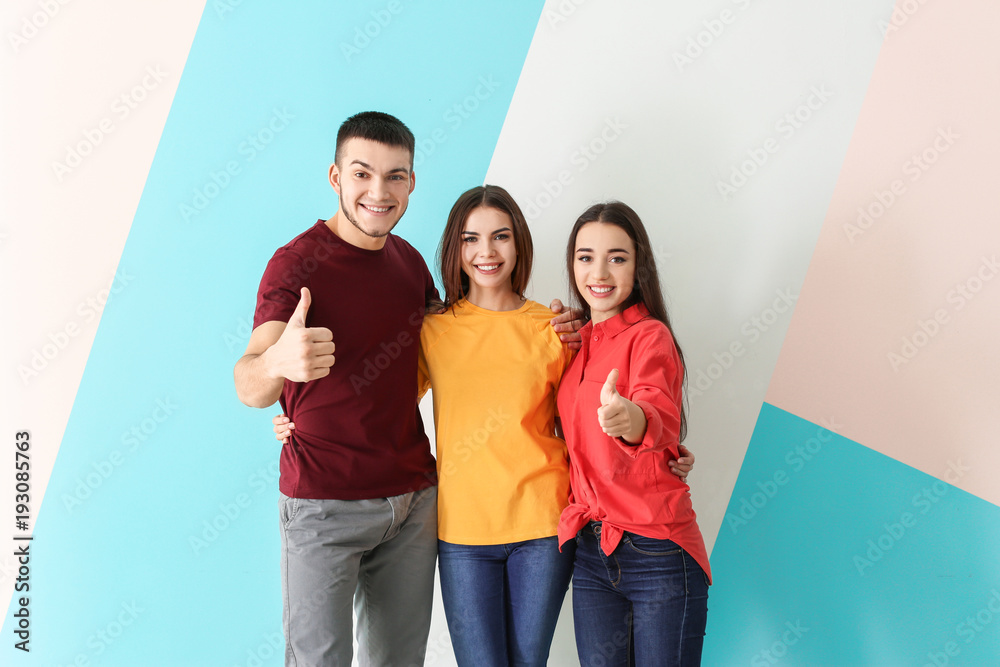 Young people posing together on color background. Unity concept Young people posing together on color background. Unity concept