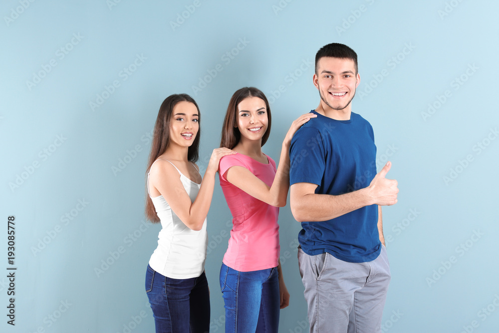Young people posing together on color background. Unity concept Young people posing together on color background. Unity concept