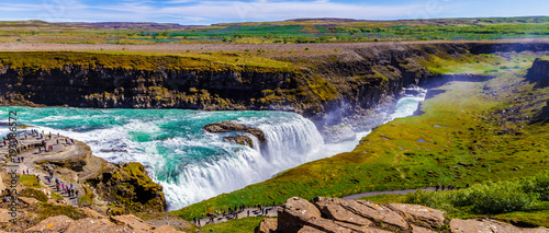 Grassy slopes and the Gullfoss waterfall in Iceland 11.06,2017