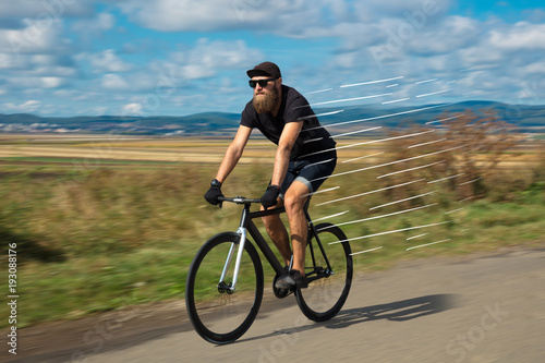 Fototapeta Naklejka Na Ścianę i Meble -  Casual cyclist riding bicycle very fast