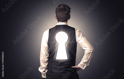 Man standing with black keyhole on his back