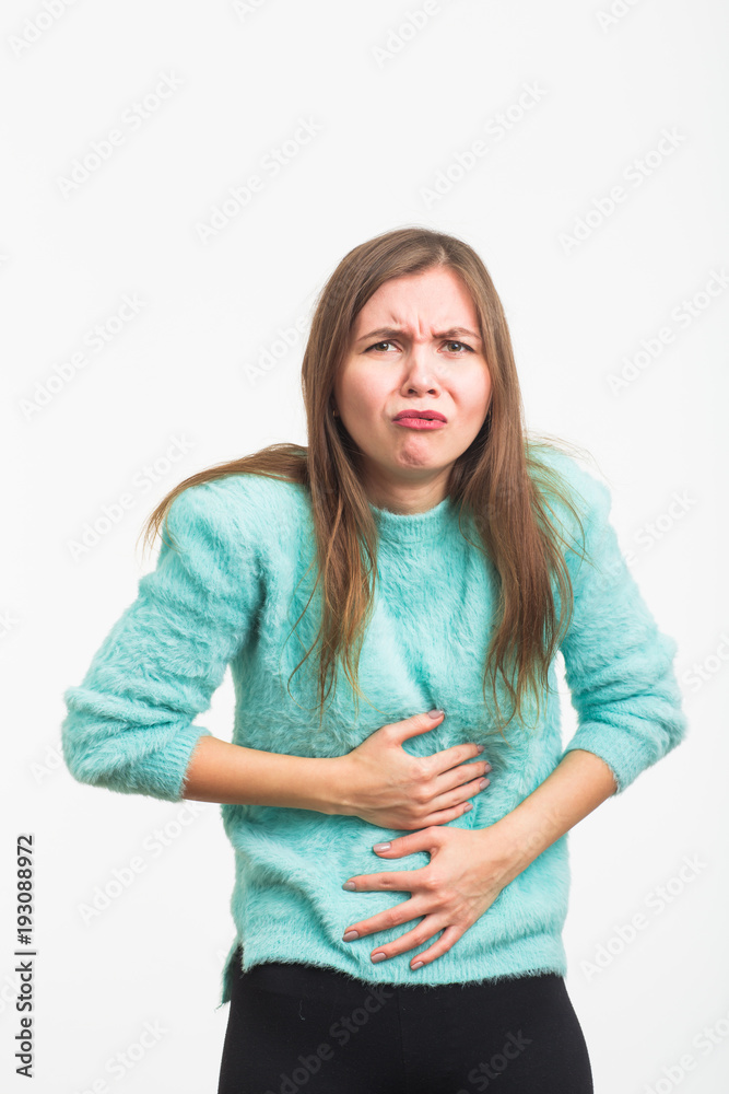 Woman with stomach pain on blue background Woman with stomach pain on blue background