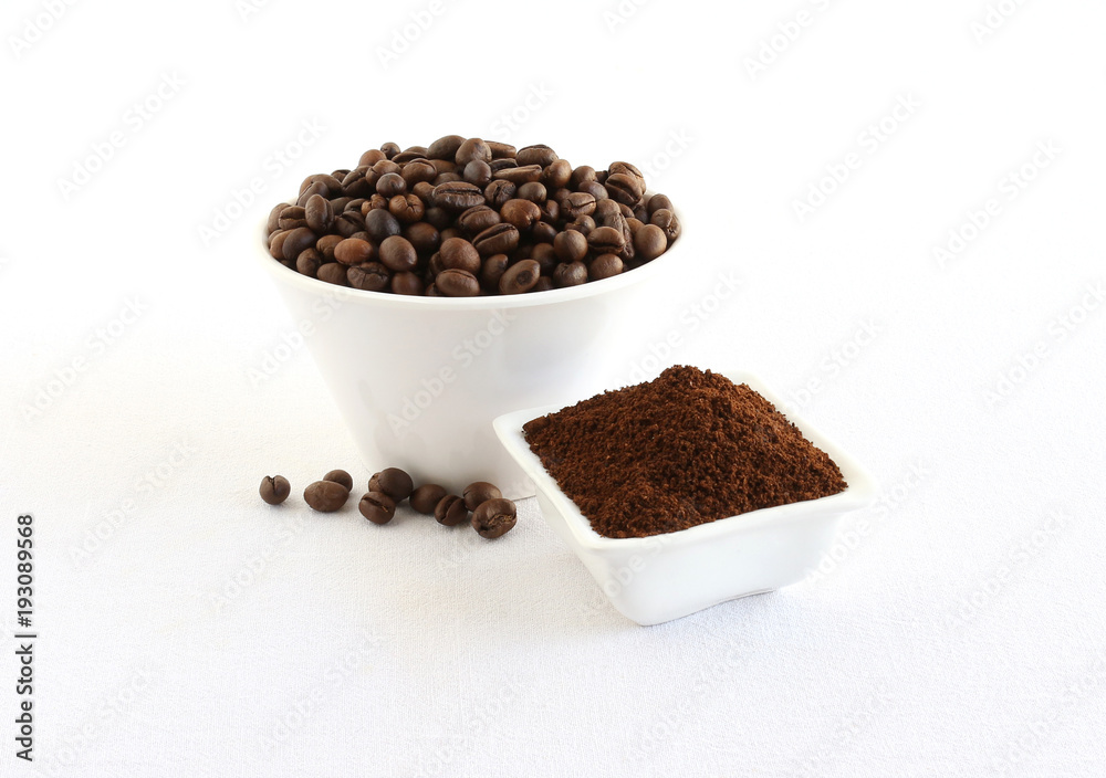 Coffee beans and powder, which is freshly ground, in bowls.