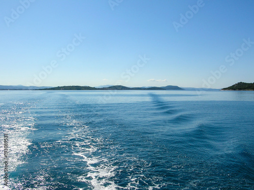 Sea water ship trail with white foamy wave. Tropical islands ferry travel. Bubble tail after cruise ship. Deep ocean view. © Roman's portfolio