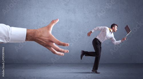 Businessman running from hand