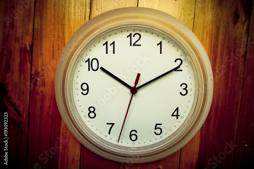 White clock on wooden wall