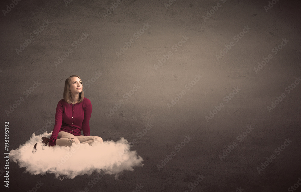 Fototapeta premium Woman sitting on a cloud with plain bakcground