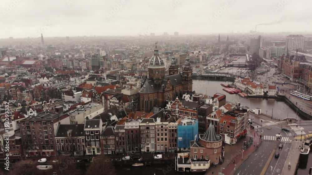 The Sint-Nicolaaskerk at the cetral station in Amsterdam, Netherlands, in an aerial shot. The Sint-Nicolaaskerk at the cetral station in Amsterdam, Netherlands, in an aerial shot.