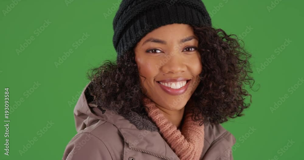 Happy Black woman rubbing her nose with her gloves during winter cold on green screen. Cute African American Millennial woman in 30s wiping nose and smiling at camera on greenscreen. 4k Happy Black woman rubbing her nose with her gloves during winter cold on green screen. Cute African American Millennial woman in 30s wiping nose and smiling at camera on greenscreen. 4k