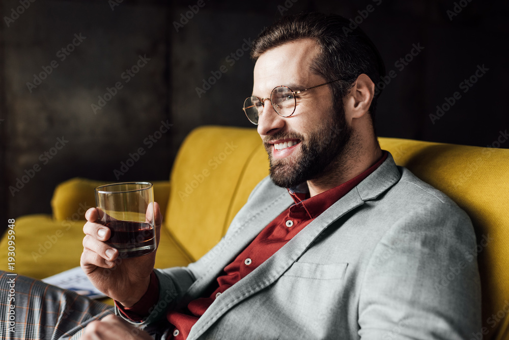 stylish cheerful man holding glass of whiskey stylish cheerful man holding glass of whiskey