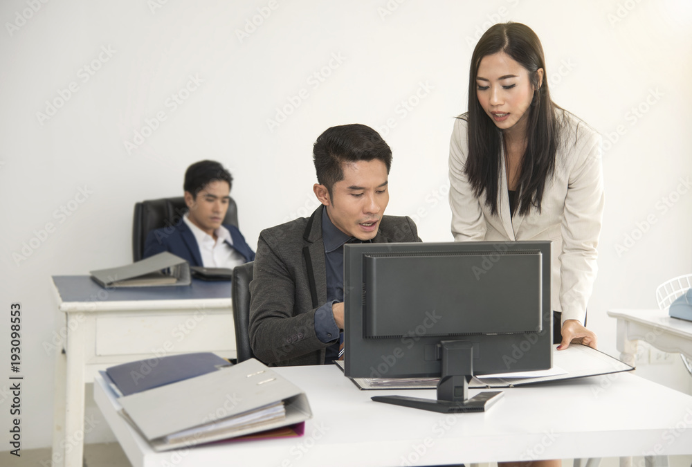 Manager and secretary consult for working in the office desk. Manager and secretary consult for working in the office desk.