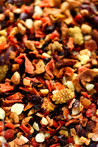 Mix tea karkade with dried fruits and flowers. Fruit tea background and texture. Top view. Food background. Organic healthy herbal leaves, detox tea. © jchizhe