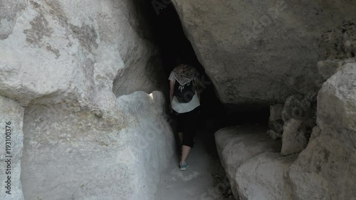 Young girl walks in cave monastery Vardzia - Georgia