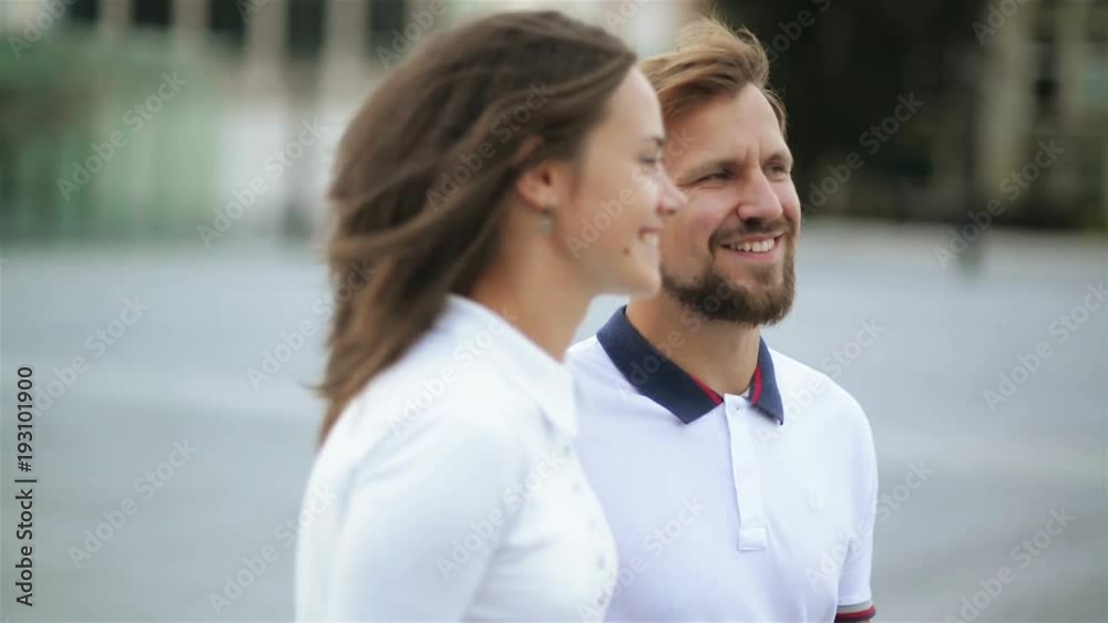 Closeup Portrait of Happy Couple in Love Walking around the City Holding Hands. Attractive Young Woman and Handsome Man Spending Time Together. Closeup Portrait of Happy Couple in Love Walking around the City Holding Hands. Attractive Young Woman and Handsome Man Spending Time Together.