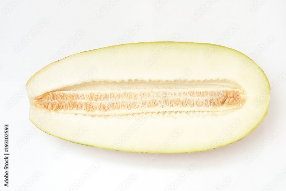 Beautiful and ripe yellow melon on a white background. Cut. With seeds Beautiful and ripe yellow melon on a white background. Cut. With seeds