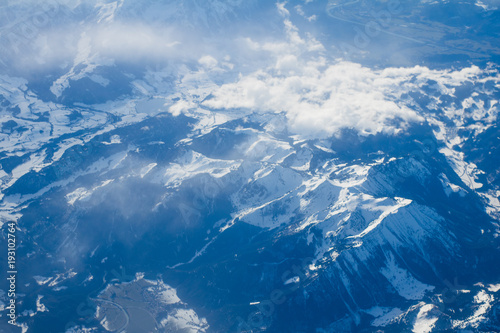 Snowy and cloudy scenic mountains scene from above