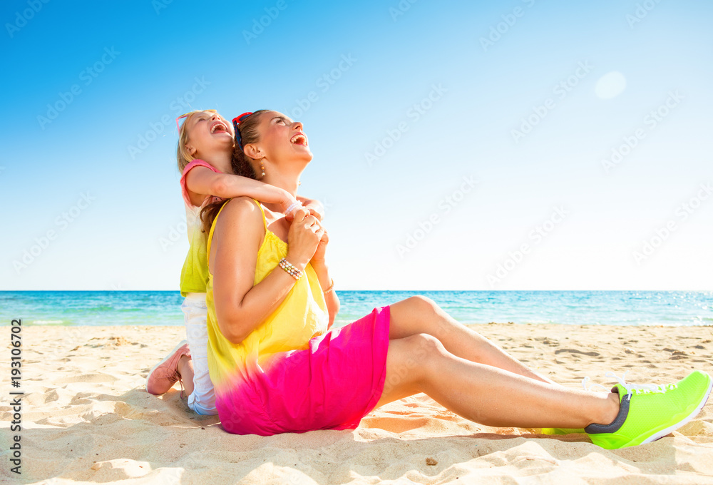 happy mother and child on beach looking at copy space happy mother and child on beach looking at copy space