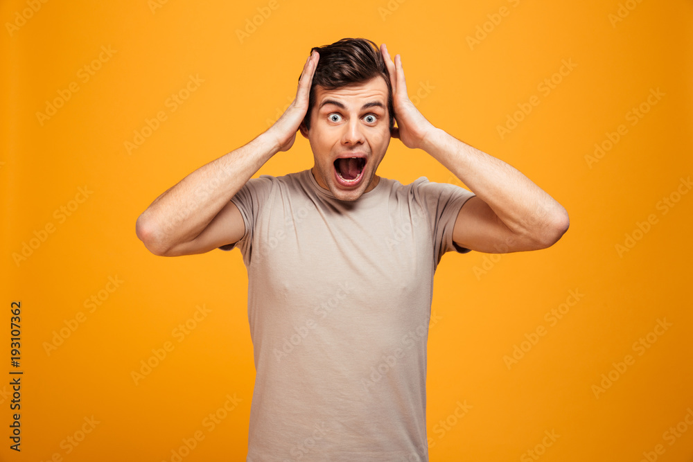 Portrait of a shocked young man screaming Portrait of a shocked young man screaming