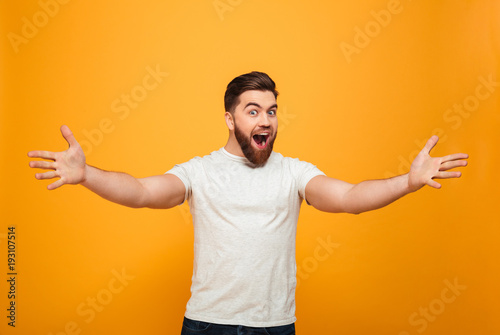 Portrait of a cheerful bearded man with outsretched hands
