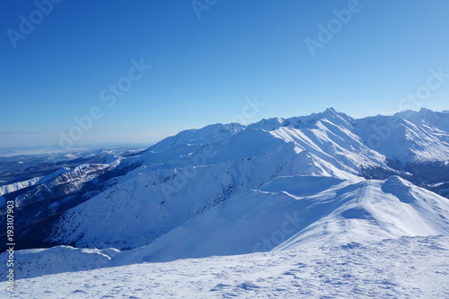 Top of Kopa Kondracka during winter with a view on Kasproway Wierch, Zakopane, Tatry mountains, Poland © Tom