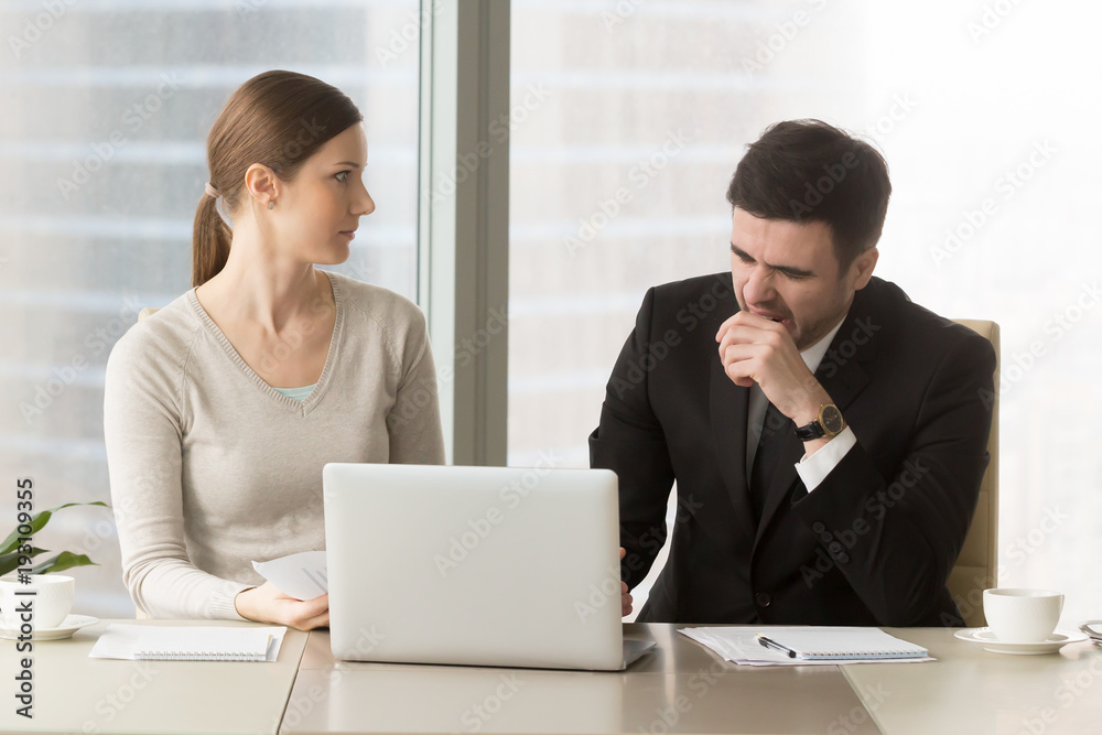 Tired businessman yawning when sitting at desk with female colleague during meeting in office, businesswoman looking with confusion on bored male coworker. Lack of sleep and narcolepsy, bad manners Tired businessman yawning when sitting at desk with female colleague during meeting in office, businesswoman looking with confusion on bored male coworker. Lack of sleep and narcolepsy, bad manners