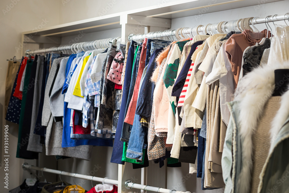 Clothes hang on a shelf in a designer store