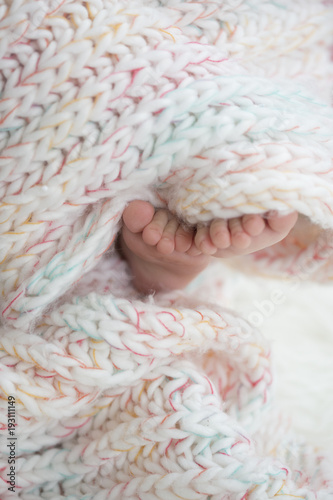baby feet in blanket, copy space. selectiv focus © arizanko