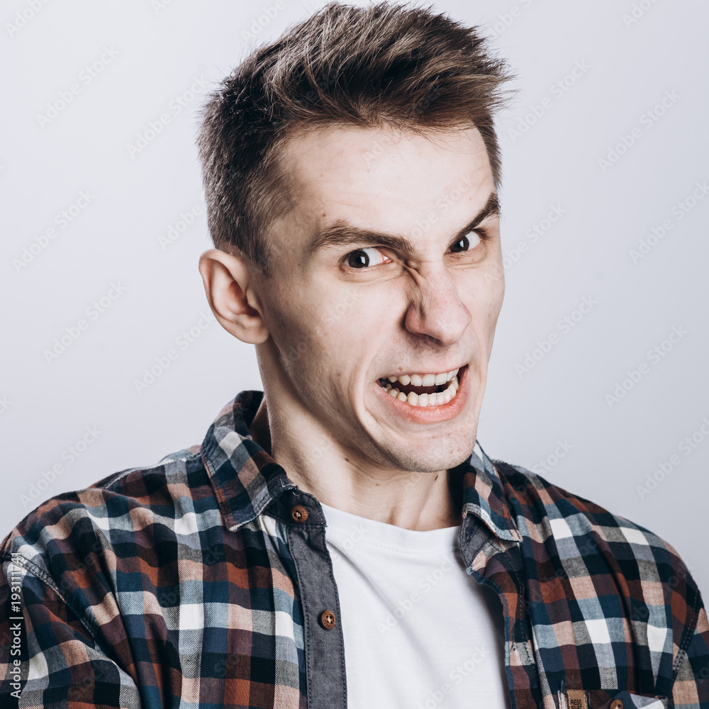 Handsome emotional man isolated over gray background Handsome emotional man isolated over gray background