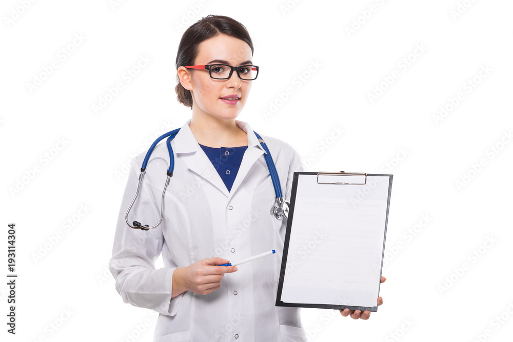 Young woman doctor with stethoscope holding pen in her hand showing on clipboard in white uniform on white background