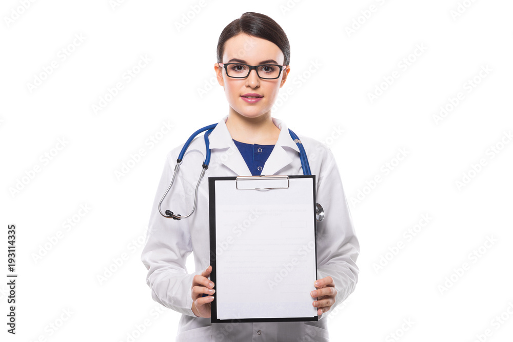 Young woman doctor with stethoscope holding in her hands and showing clipboard in white uniform on white background Young woman doctor with stethoscope holding in her hands and showing clipboard in white uniform on white background