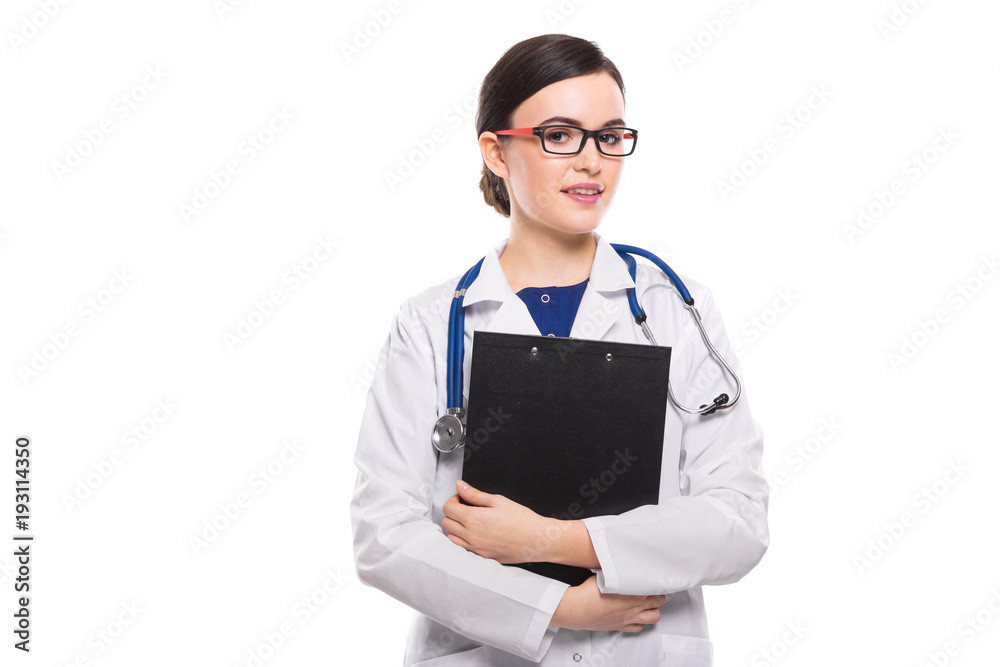 Young woman doctor with stethoscope holding clipboard with her hands in white uniform on white background Young woman doctor with stethoscope holding clipboard with her hands in white uniform on white background