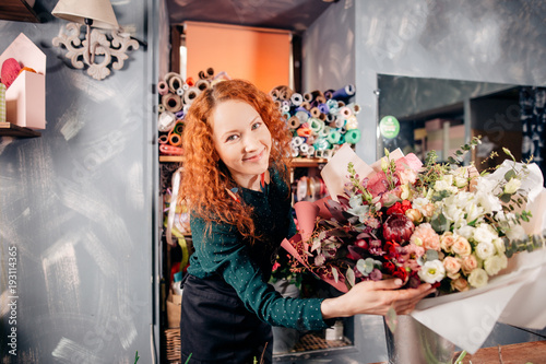 shot of beautiful girl with beautiful flowers at work, happy job. amateur of flovers. lover of flowers photo