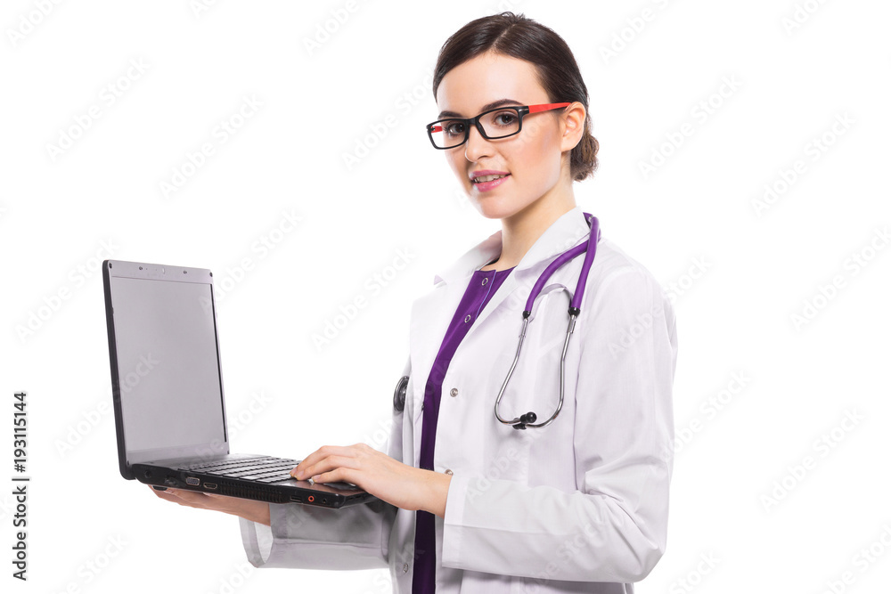 Young woman doctor with stethoscope holding laptop in her hands in white uniform on white background Young woman doctor with stethoscope holding laptop in her hands in white uniform on white background