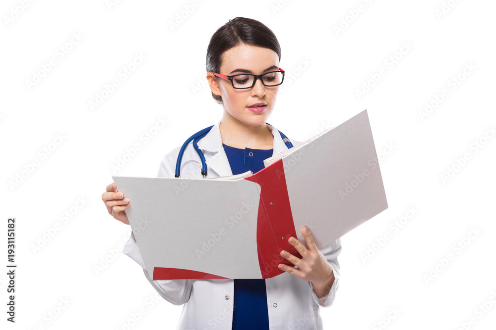 Young woman doctor with stethoscope holding binder in her hands in white uniform on white background Young woman doctor with stethoscope holding binder in her hands in white uniform on white background
