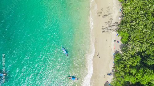 Aerial view shooting of Phuket beach, Phuket, Thailand, Aerial view Tropical white sand beach with azure clear water, umbrella and lush greenery.