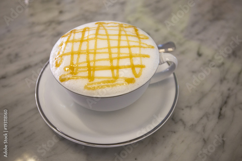 a cup of hot caramel macchiato on Mable table