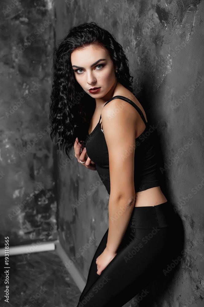 Fototapeta premium beautiful girl in the black topic and lacines in the studio 