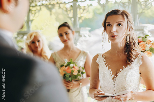 Bride holds a book while she tells her vow on the wedding ceremony