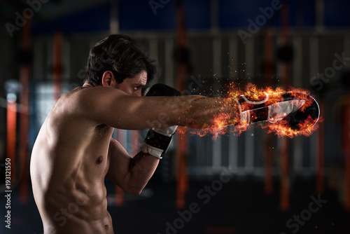 Confident boxer with fiery boxing gloves
