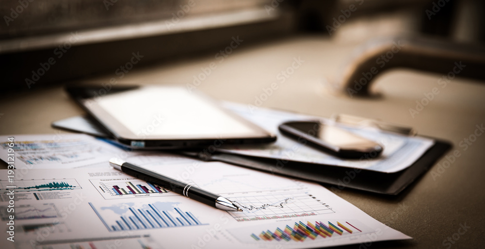 Fototapeta premium business documents with charts growth, keyboard and pen.