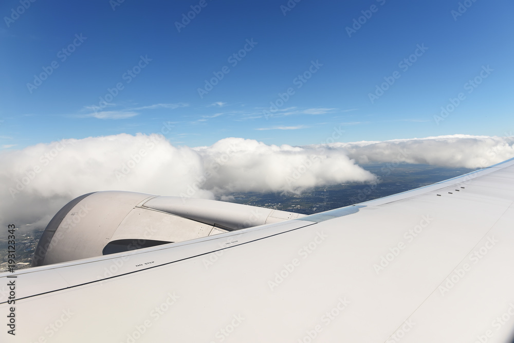 The view from the plane to the wing of the aircraft and motor the terrain at the bottom. The atmosphere of travel.
