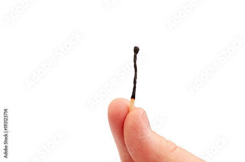 Two fingers holding a fired matchstick isolated on a white background