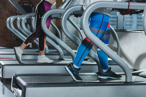 low section of women training on treadmills