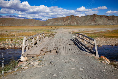 Worn down wooden bridge in Altai Mountains Mongolia photo