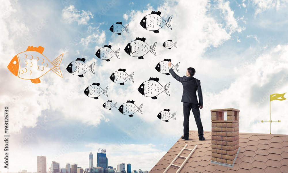 Businessman standing with back on house brick roof and drawing. Businessman standing with back on house brick roof and drawing.