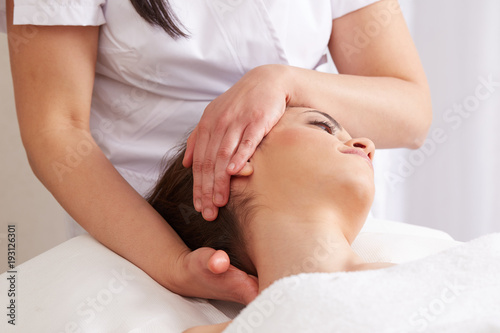 Female Enjoying Relaxing face Massage In Cosmetology Spa Center