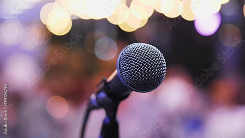 Microphone on the Stand is Standing on the Stage, Close-Up Microphone on the Background of the Auditorium, Spotlight