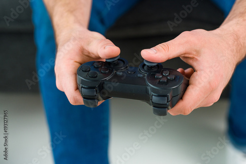 partial view of man playing video game at home