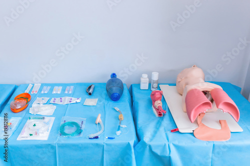 Salvation of life in emergency situations. Equipment for the exam about tracheostomy. Medical students take exams. background medical mannequins photo