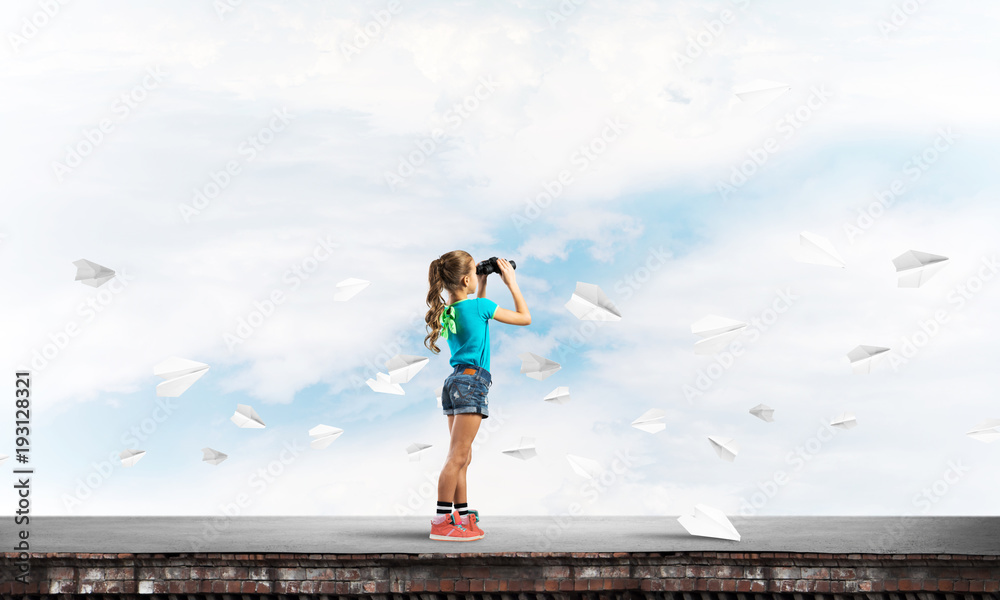 Concept of careless happy childhood with girl of school age looking in future Concept of careless happy childhood with girl of school age looking in future